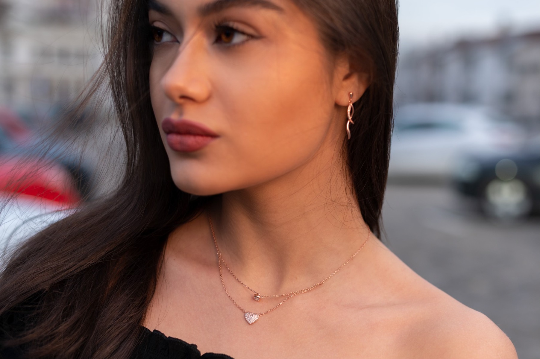 Charming women's dangle earrings made entirely of soft rose silver with exquisitely shaped curves, embellished with dazzling cubic zirconias. Fastening with a pin is for more convenience and comfort.