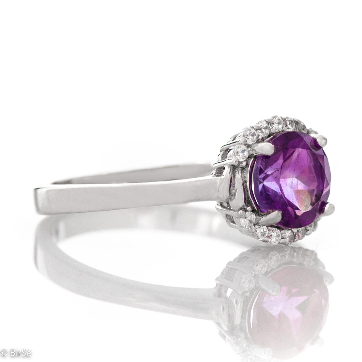 An elegant women's ring made of a delicate combination of rhodium-plated silver, natural amethyst and sparkling zircons. Part of a silver pendant and earring set from the same collection and the same striking design.