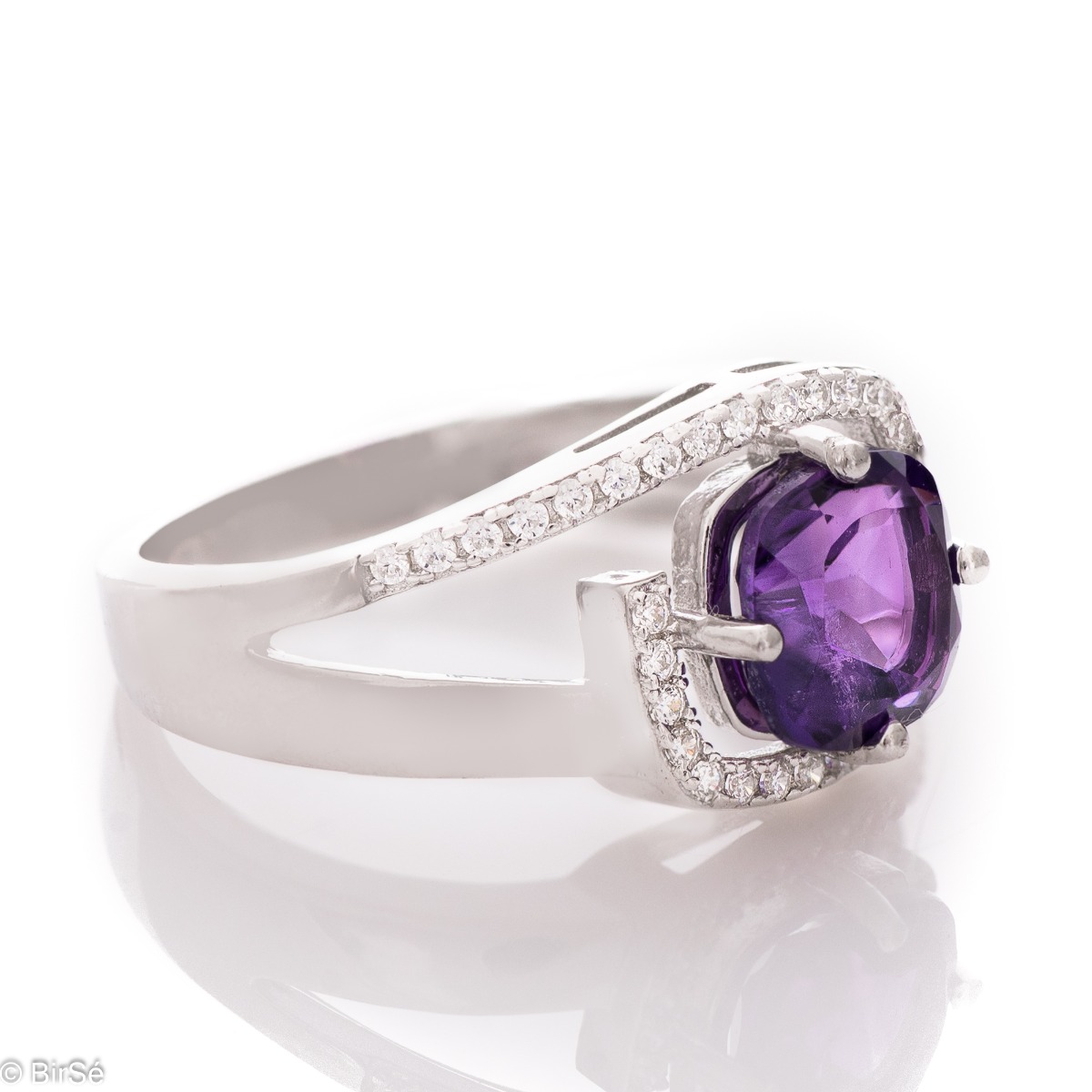 An elegant silver ring with an exquisite design, centered with a sparkling Amethyst, also known as the "Stone of Dreams". Delicate zircons add more sparkle to the jewelry.