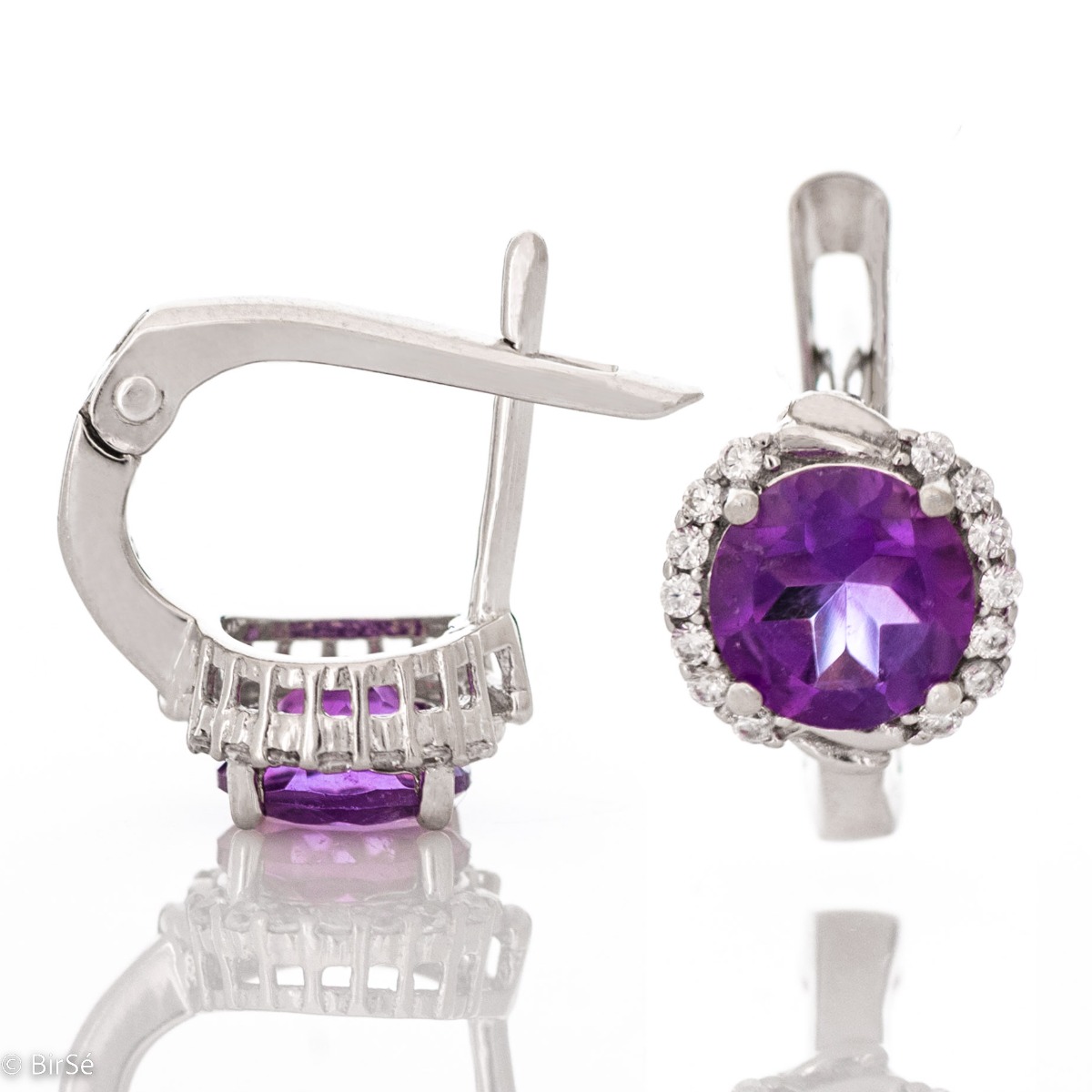 Magnificent earrings in delicate rhodium silver. An enchanted round-shaped amethyst rests in the center, surrounded by spectacular cubic zirconias. A beautiful jewel with a mysterious charm. For ladies who prefer unobtrusive jewelry.