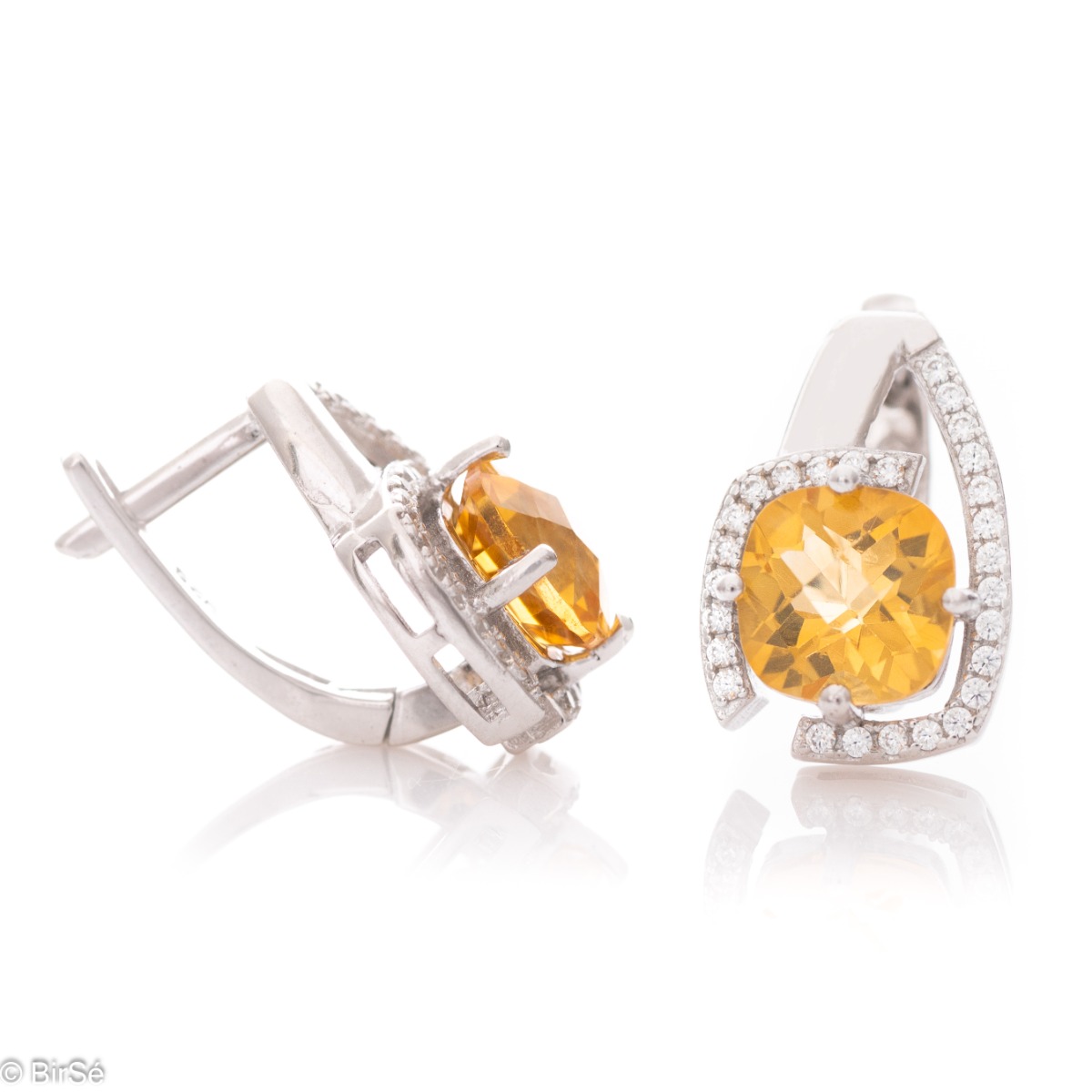 Elegant ladies earrings with English clasp and radiant natural citrine, complemented by sparkling zircons and a stylish design entirely in rhodium silver.