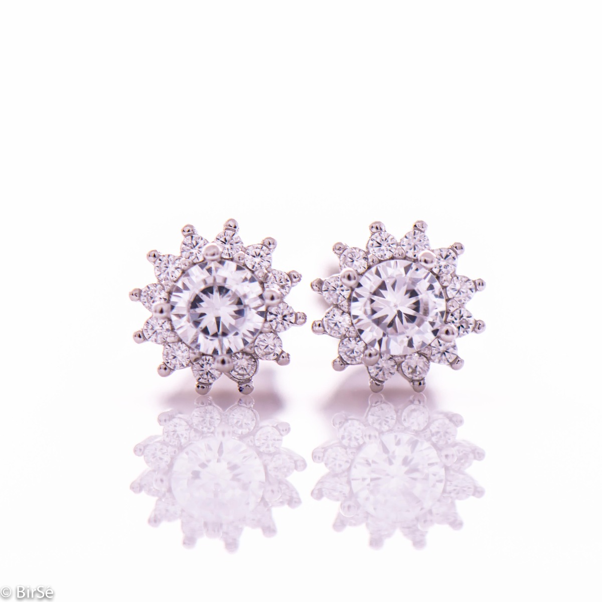 Delicate silver snowflake earrings made of rhodium silver with a captivating design. The sparkling zircons adorning the earrings turn them into a charming piece of jewelery desired by ladies.