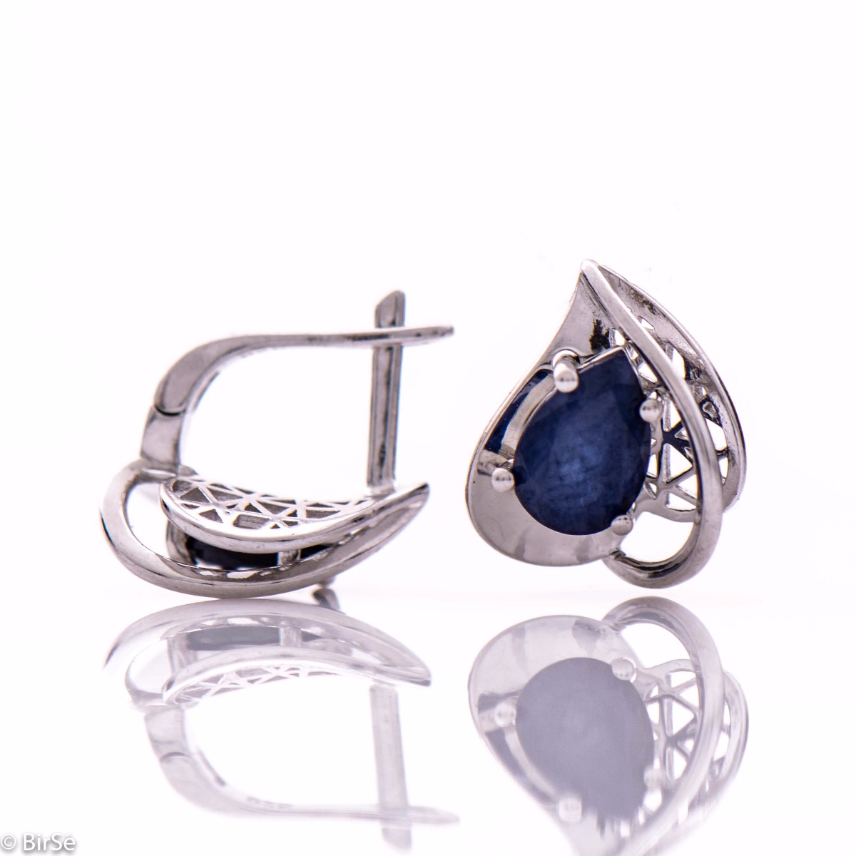 Elegant women's earrings in a modern arrangement of geometric elements and shapes, made of a stylish combination of rhodium-plated soft silver and radiant natural sapphire. Part of an exclusive set with a beautiful ring and pendant.