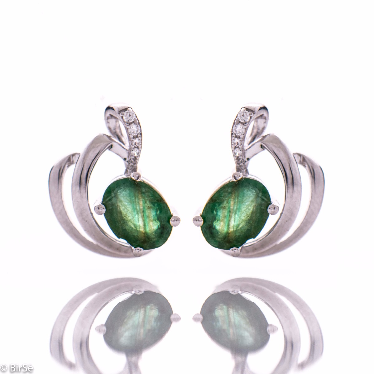 A lustrous natural emerald stone interlaced with delicate sparkling zircons and exquisitely crafted with precision to detail entirely in beautiful rhodium silver - our new ladies English clasp earrings. In an exclusive pendant and ring set.