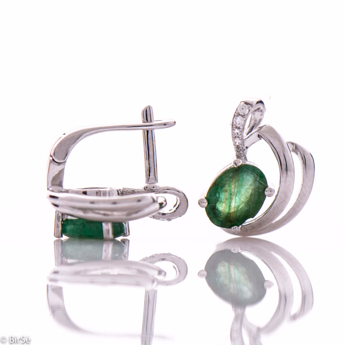 A lustrous natural emerald stone interlaced with delicate sparkling zircons and exquisitely crafted with precision to detail entirely in beautiful rhodium silver - our new ladies English clasp earrings. In an exclusive pendant and ring set.