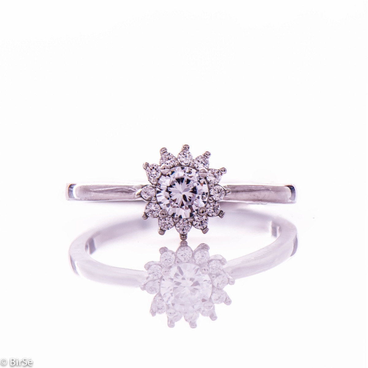 Beautifully sculpted ring in rhodium-plated silver with a delicate sparkling flower in the center of cubic zirconia. Be a princess with this amazing piece of jewelry.