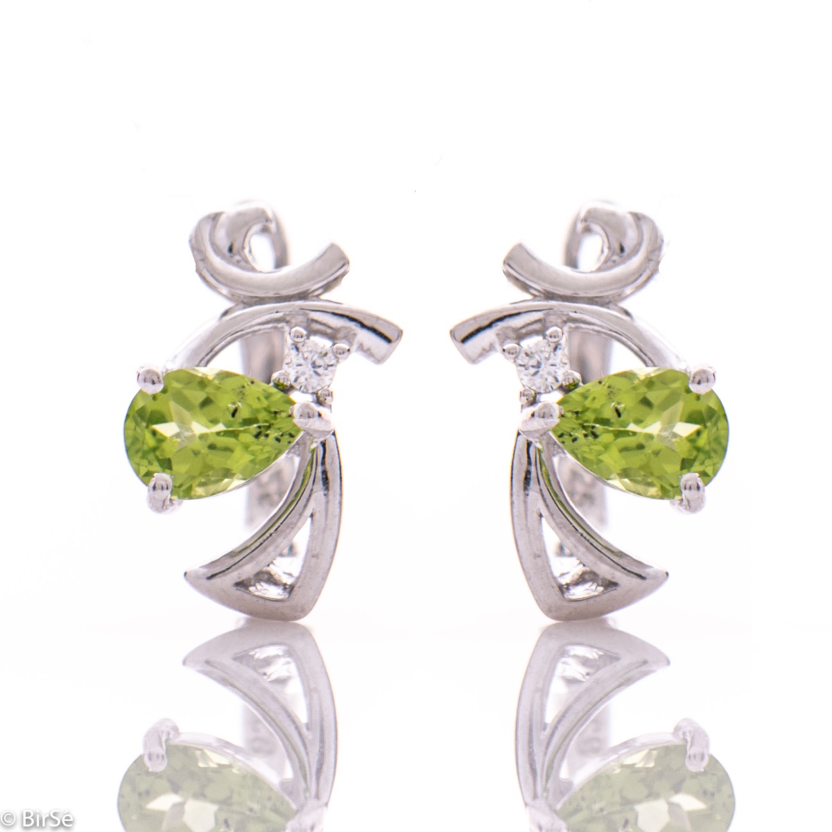 Exquisite women's earrings with English clasp and spectacular craftsmanship, interweaving a radiant natural peridot stone, in a beautiful teardrop shape, with sparkling zircon and delicate curves of rhodium silver. In a charming ring and pendant set.