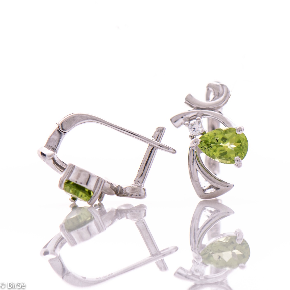 Exquisite women's earrings with English clasp and spectacular craftsmanship, interweaving a radiant natural peridot stone, in a beautiful teardrop shape, with sparkling zircon and delicate curves of rhodium silver. In a charming ring and pendant set.