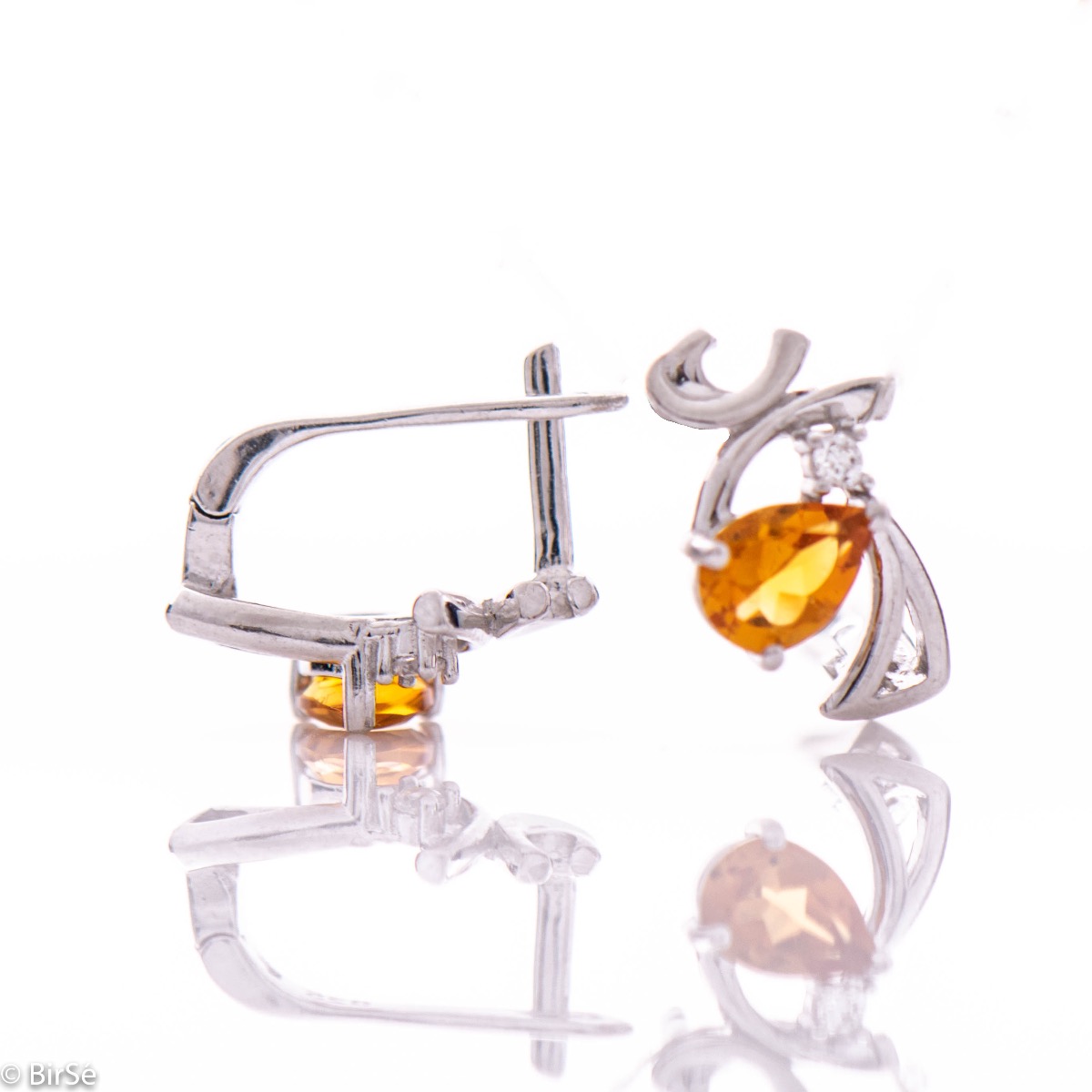 Spectacular craftsmanship of our new ladies English clasp earrings, interweaving a radiant natural citrine stone, in an exquisite teardrop shape, with delicate zircon and captivating curves of rhodium silver. Complete with an exclusive ring.