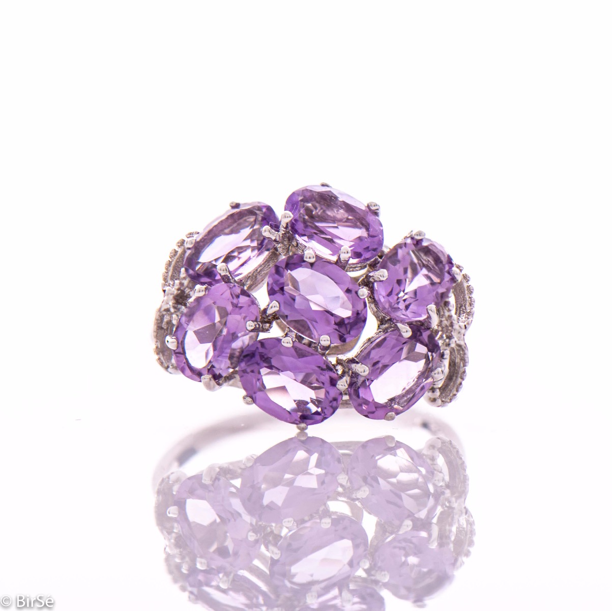 Dazzling ring with a spectacular craftsmanship entirely of rhodium-plated silver combined with a radiant natural amethyst. Part of an exclusive sterling silver three-piece set - featuring lovely earrings and a pendant.