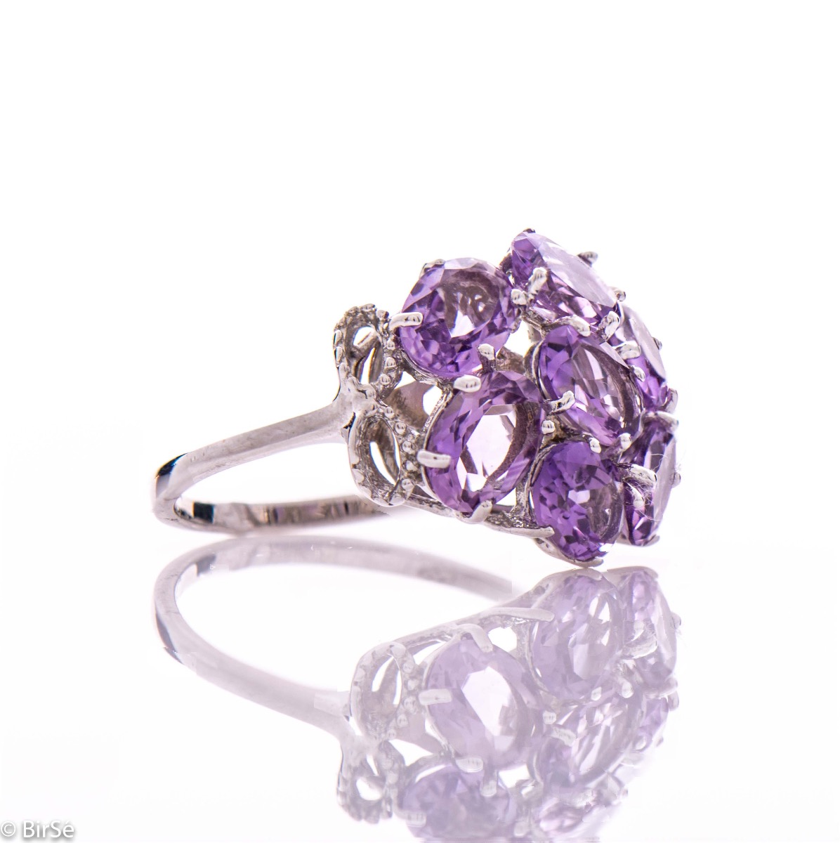 Dazzling ring with a spectacular craftsmanship entirely of rhodium-plated silver combined with a radiant natural amethyst. Part of an exclusive sterling silver three-piece set - featuring lovely earrings and a pendant.