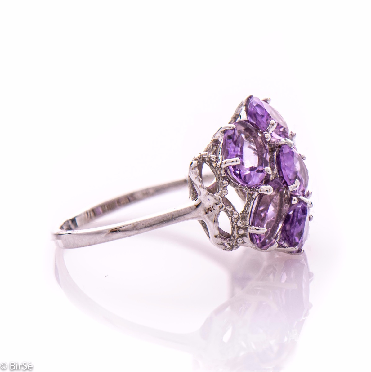 Dazzling ring with a spectacular craftsmanship entirely of rhodium-plated silver combined with a radiant natural amethyst. Part of an exclusive sterling silver three-piece set - featuring lovely earrings and a pendant.