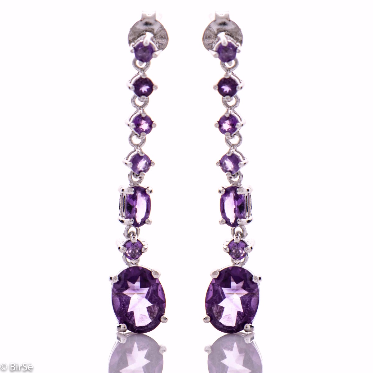 Radiant and spectacular dangling stud earrings with multi-faceted and variously shaped natural amethyst stones and delicately crafted from fine rhodium silver.