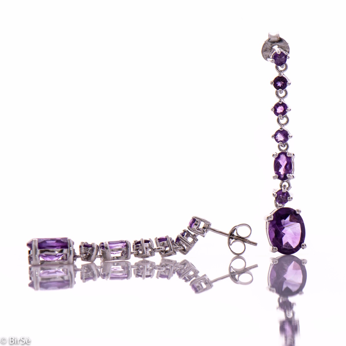 Radiant and spectacular dangling stud earrings with multi-faceted and variously shaped natural amethyst stones and delicately crafted from fine rhodium silver.