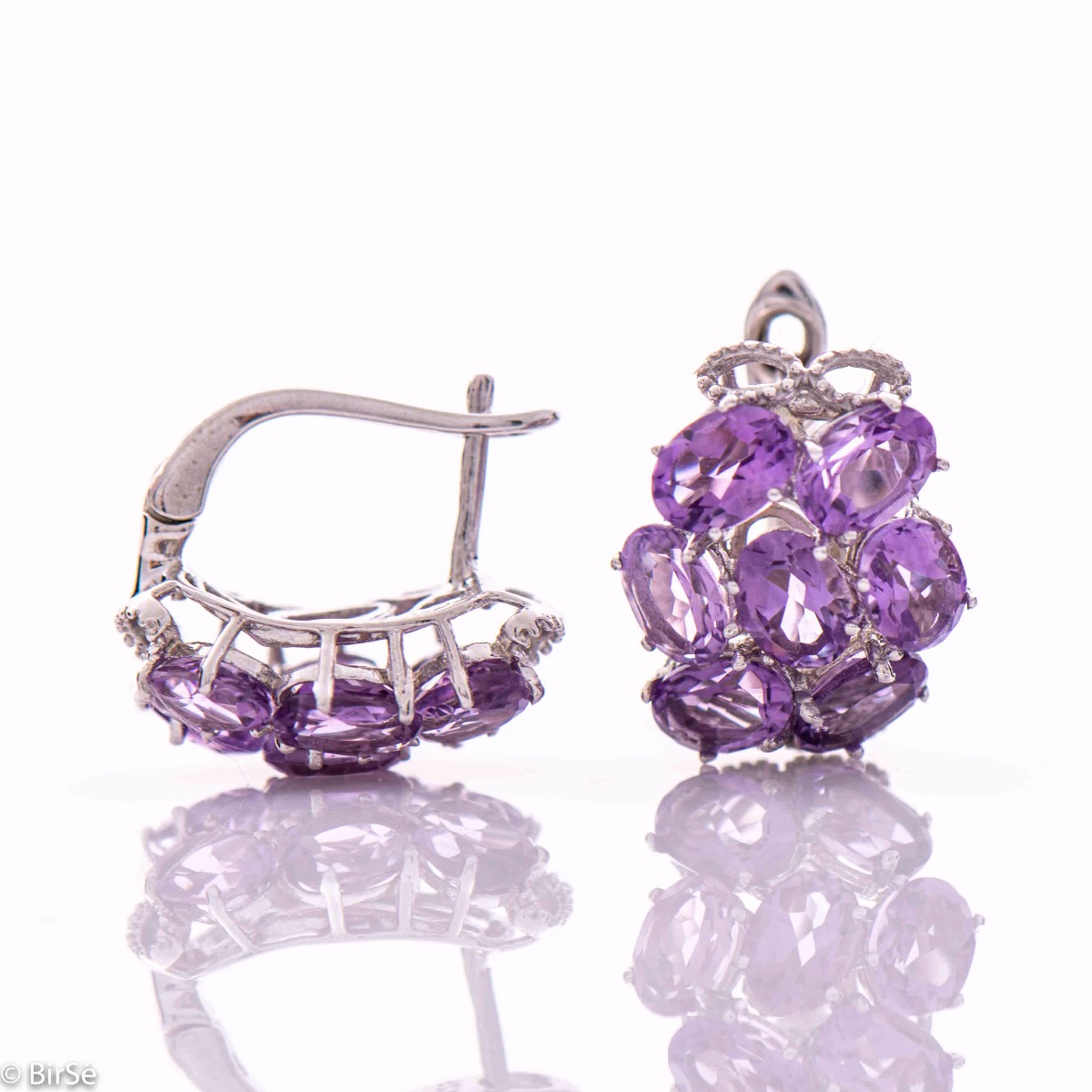 Spectacular earrings with exquisite workmanship entirely of soft rhodium silver combined with the glow of a natural amethyst stone. Part of an exclusive sterling silver three-piece set - with a lovely ring and pendant.