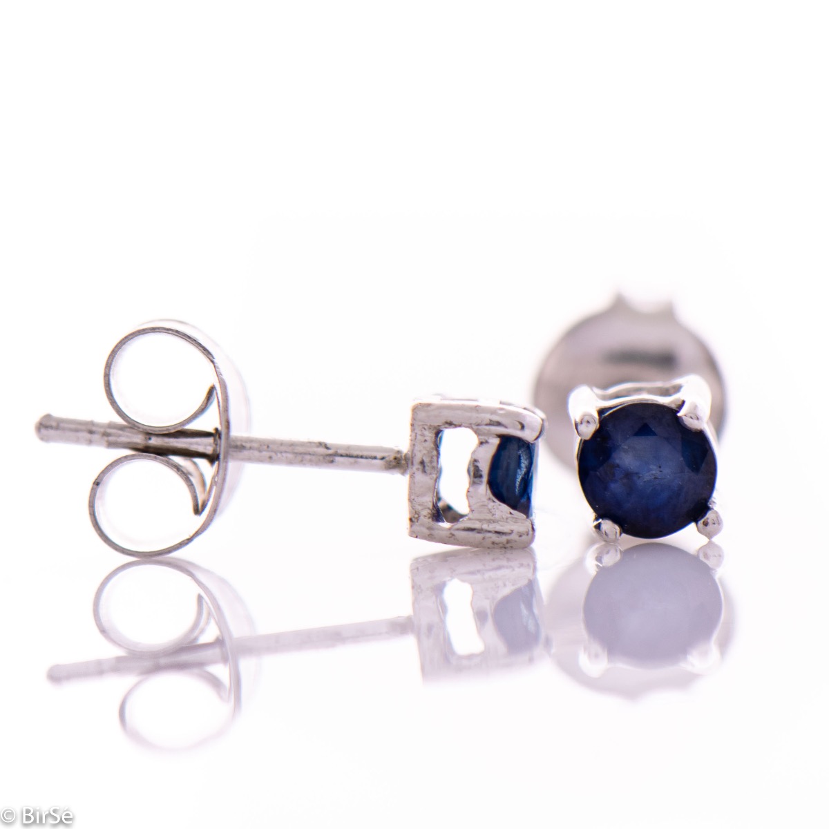 Delicate stud earrings with fine craftsmanship intertwining beautiful rhodium silver and radiant natural sapphire.