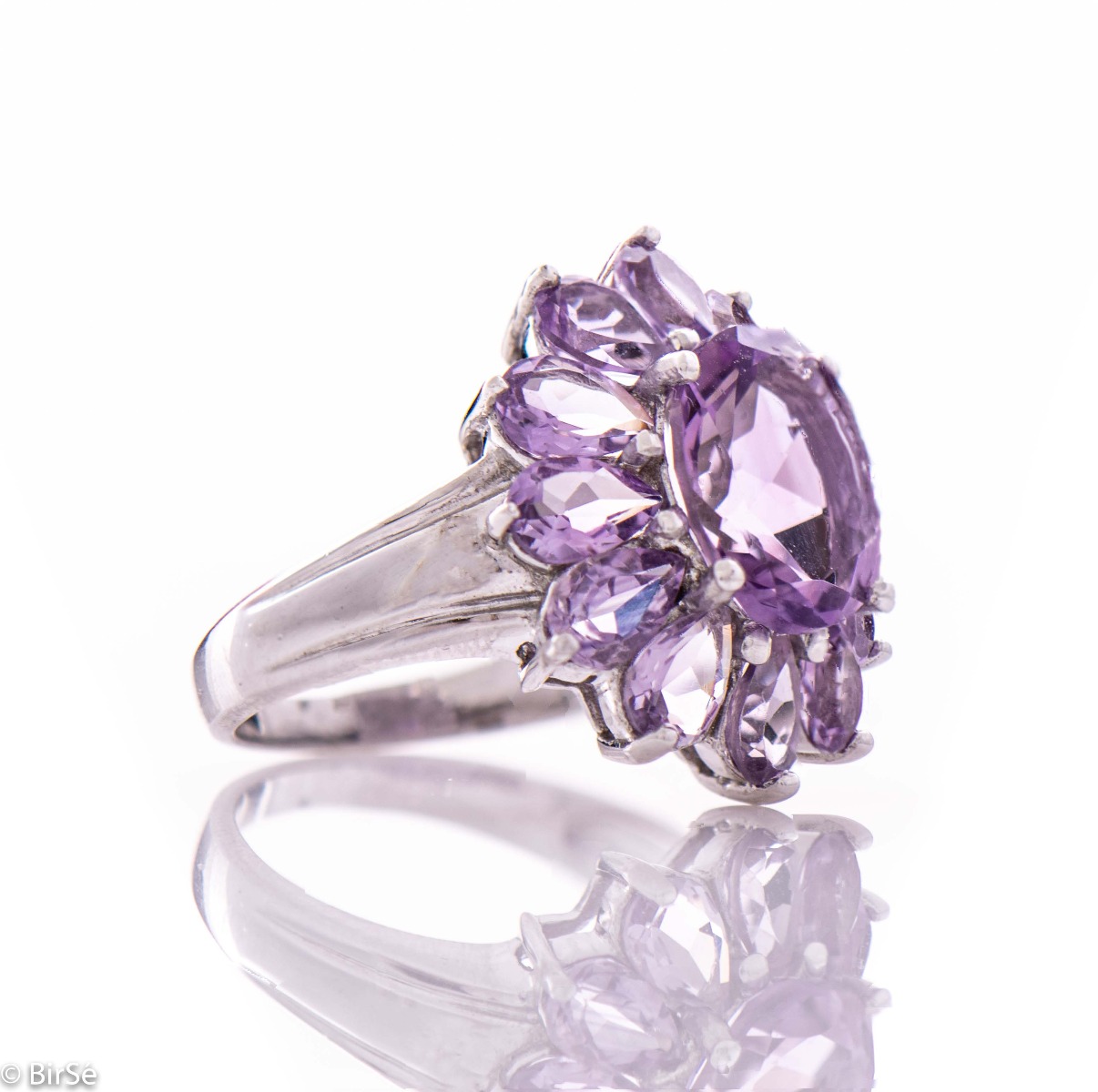 A delicate beautiful flower of natural sparkling amethysts and rhodium silver. The unique ring is suitable for ladies who prefer large jewelry. It can be combined with suitable earrings and a pendant.