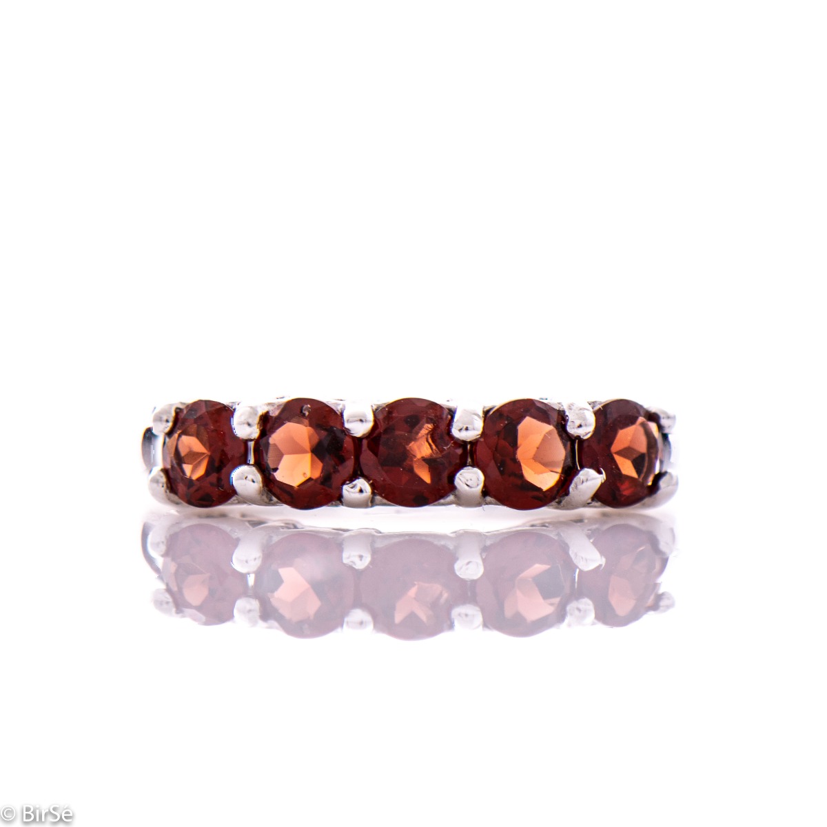 Gentle charm in the form of a lady's ring made of radiant rhodium silver and a row of fine natural garnet stones. A simple yet effective piece of jewelry. It can be combined with a bracelet, earrings and a pendant with garnets. A beautiful gift for any oc