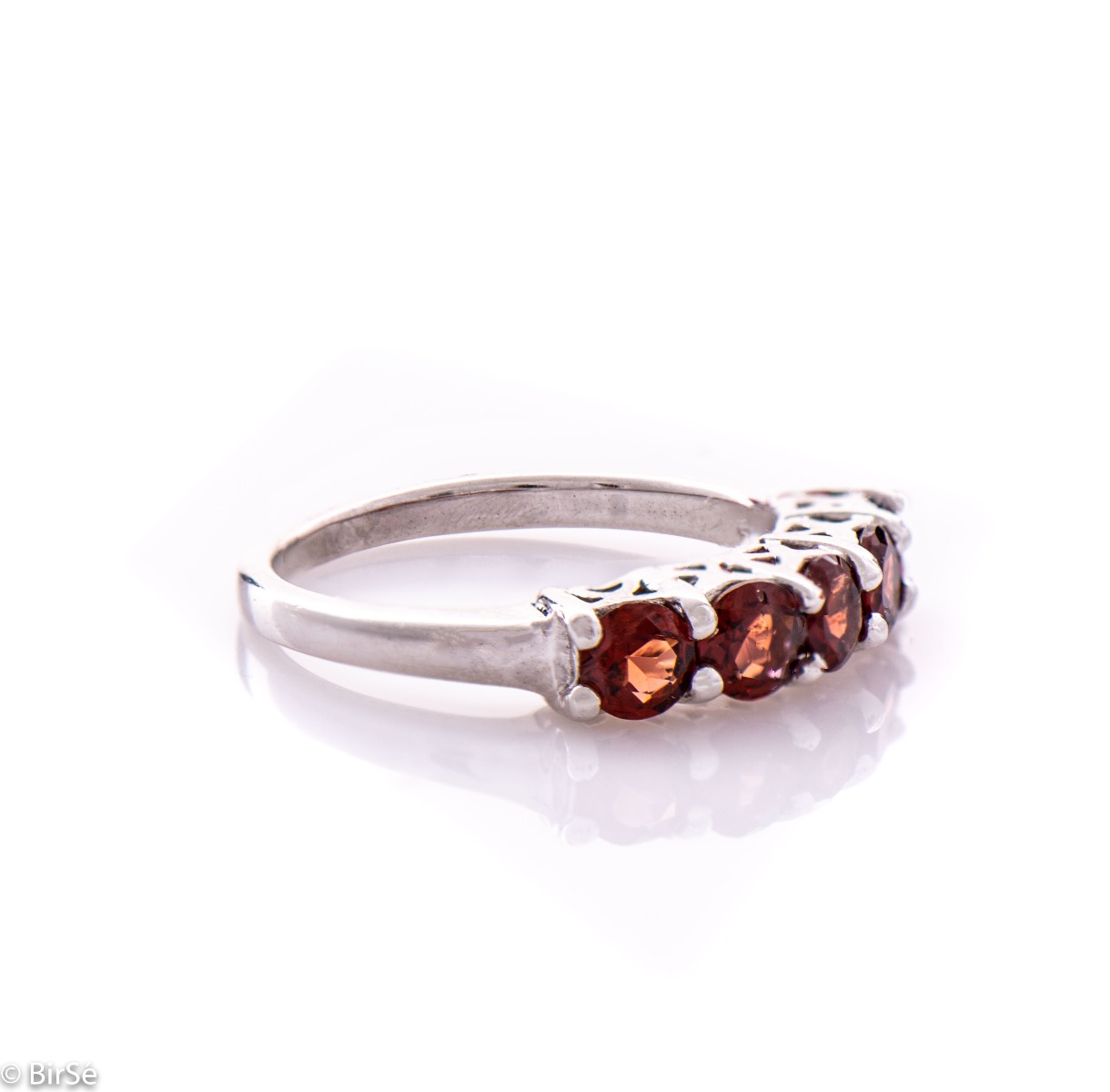 Gentle charm in the form of a lady's ring made of radiant rhodium silver and a row of fine natural garnet stones. A simple yet effective piece of jewelry. It can be combined with a bracelet, earrings and a pendant with garnets. A beautiful gift for any oc