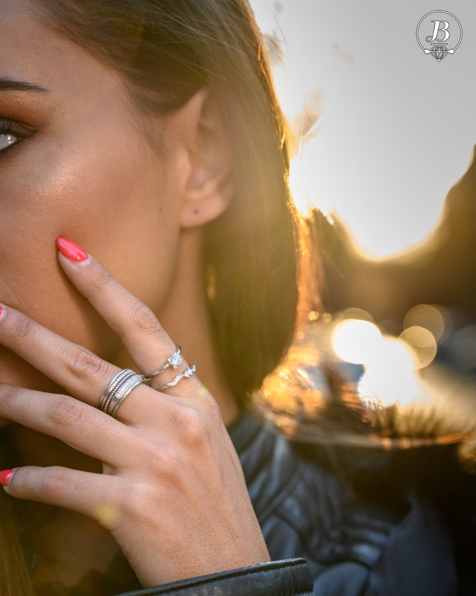 A delicate women's ring with an extremely interesting and stylish shape. An elegant combination of rhodium-plated silver and zircons.