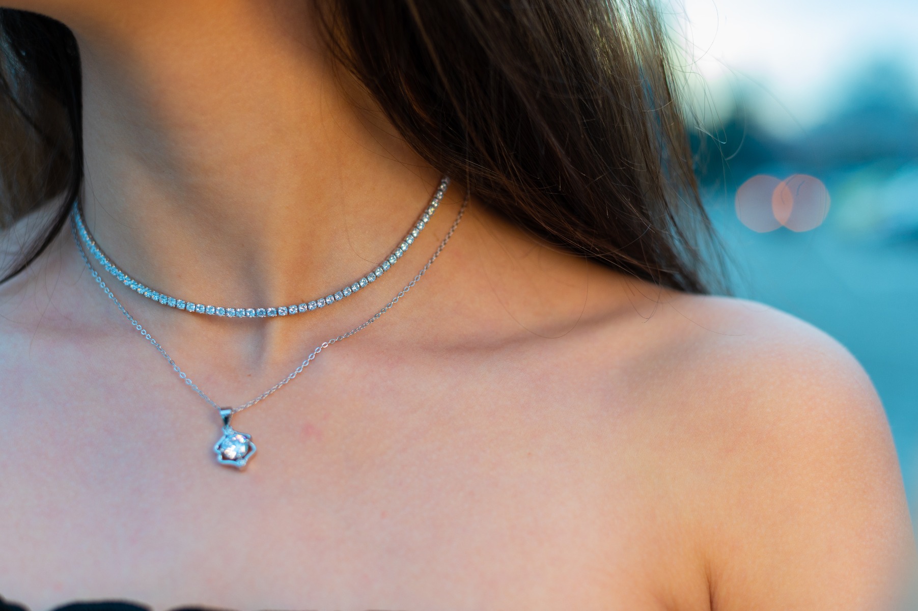 Stylish women's silver necklace, made entirely of rhodium-plated silver and covered with sparkling zircons. The necklace is an adjustable elevator type size, extremely convenient for formal outfits.