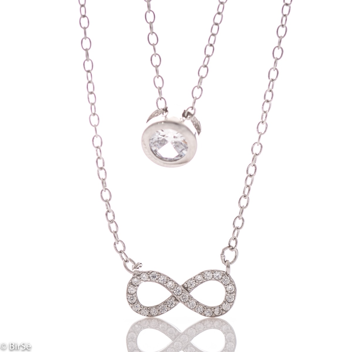 A double silver necklace with a spectacular design entirely of rhodium-plated silver and two delicate elements of a dazzling infinity and a central zircon.