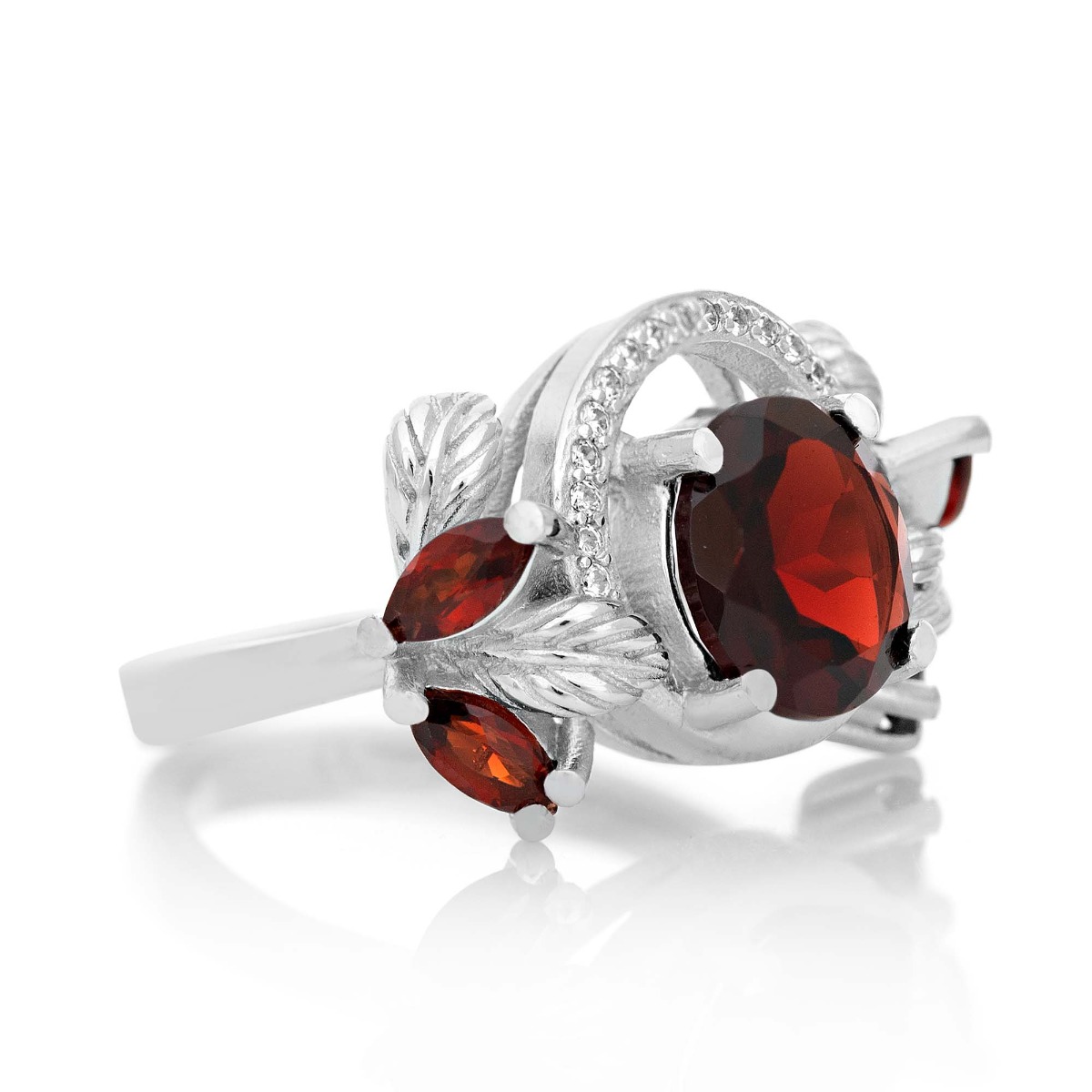 An elegant women's ring with a spectacular design entirely of rhodium-plated silver with floral elements, combined with a radiant natural garnet and sparkling zircons. Can be combined with earrings and pendant of the same model.