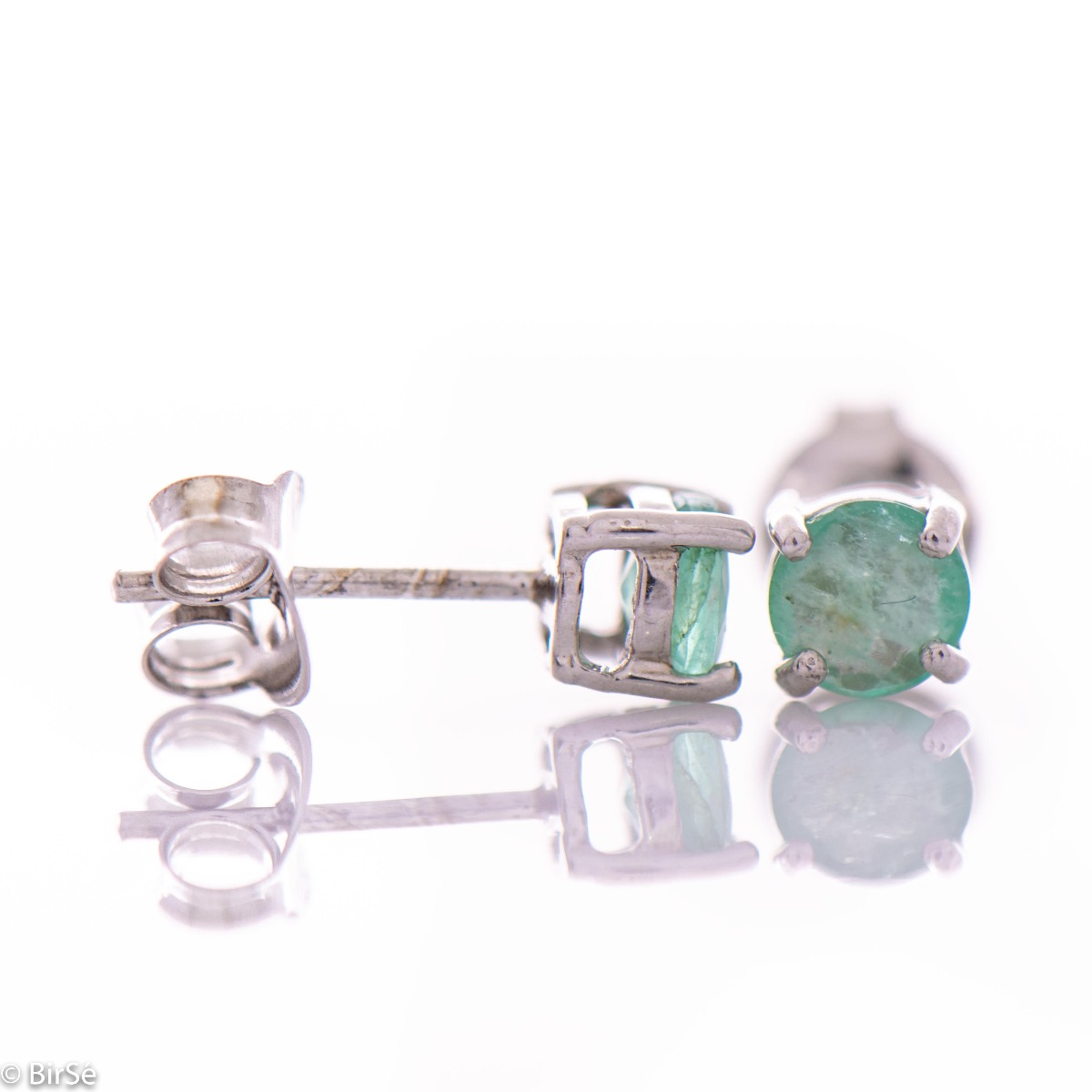 Delicate and radiant stud earrings exquisitely crafted entirely from rhodium-plated silver, delicately intertwined with the luster of a natural emerald stone.