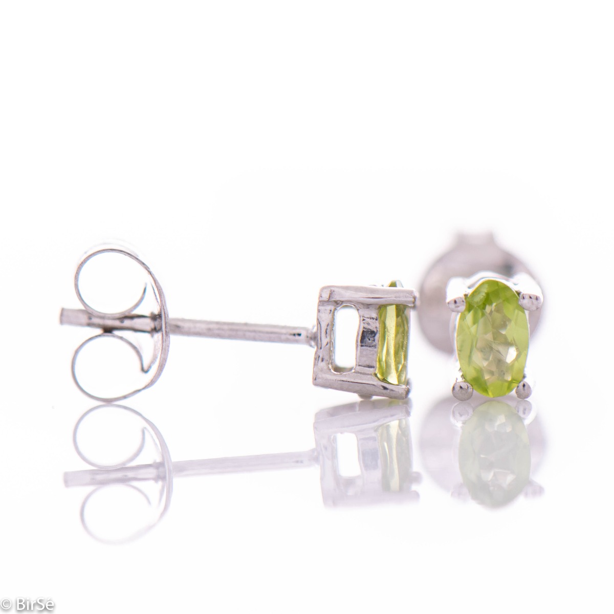 Fine craftsmanship and exquisite interweaving of soft rhodium silver with the sparkle of natural peridot stone - our new stud earrings.