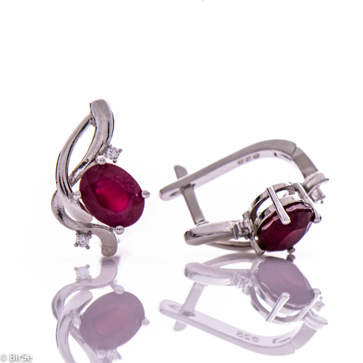 Delicate and elegant earrings in fine rhodium silver, charmingly intertwined with radiant natural ruby ​​and zircons.