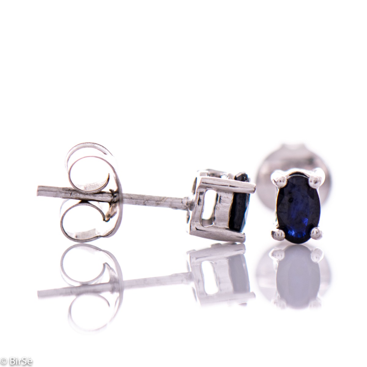 Extremely fine women's earrings in delicate rhodium silver on a stud, complemented by the brilliance of a natural sapphire.