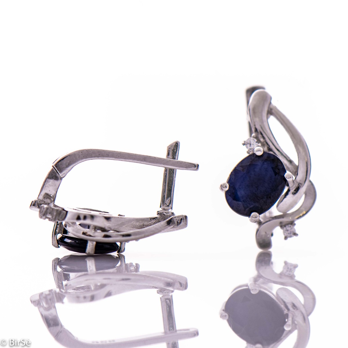 Elegant silver earrings with a gentle glow of natural sapphire and sparkling zircons.