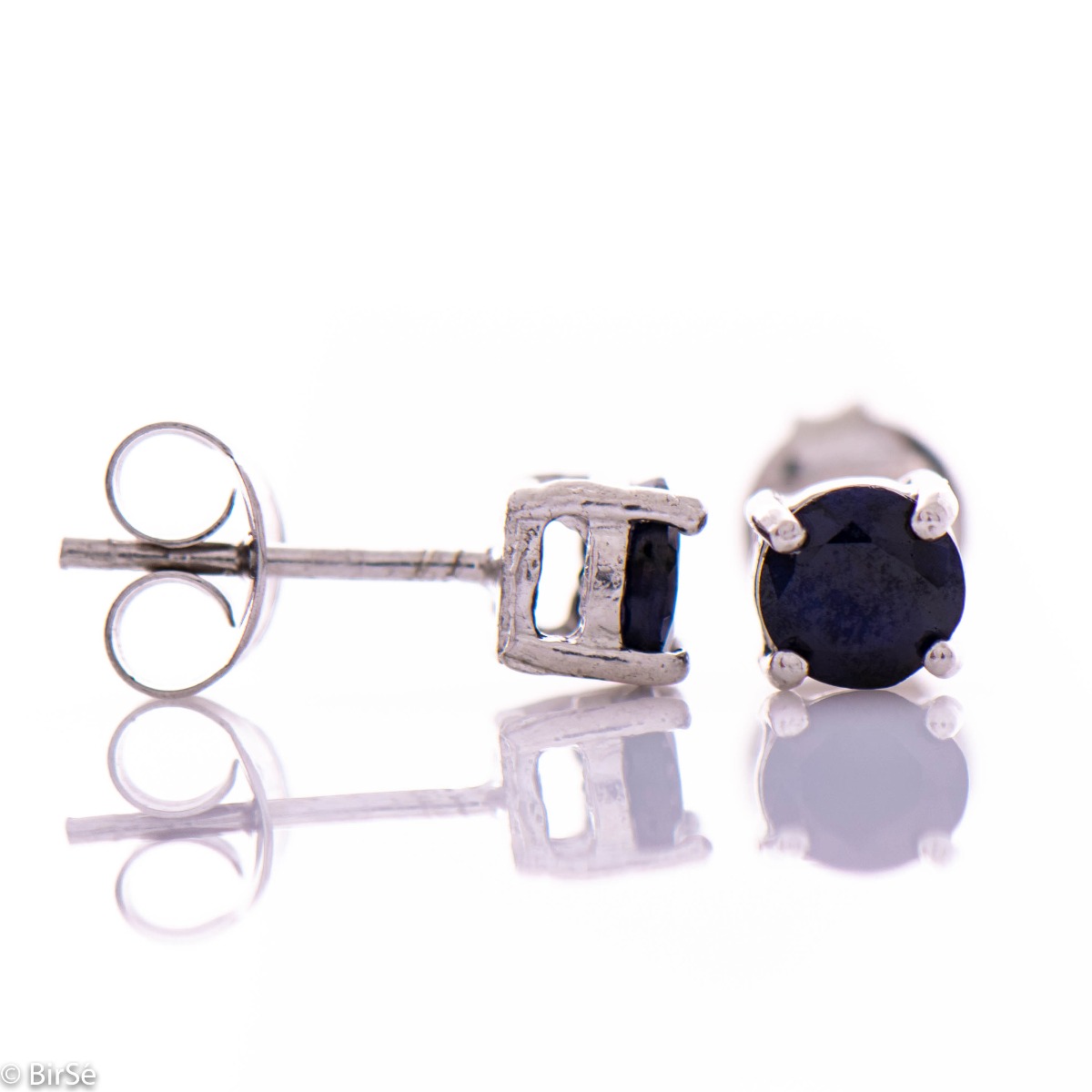 Exquisite and delicate stud earrings with a beautiful combination of rhodium silver and the delicate glow of a natural sapphire stone.