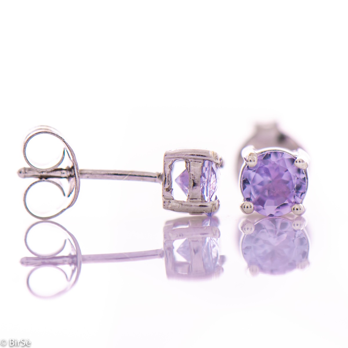 Exquisite and delicate stud earrings with a beautiful combination of natural tanzanite stone with soft rhodium silver.