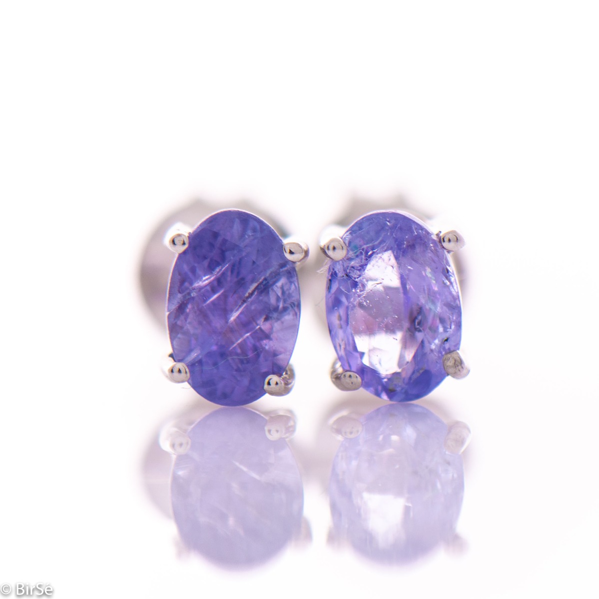 Exquisite and delicate stud earrings with a beautiful combination of natural tanzanite stone with soft rhodium silver.