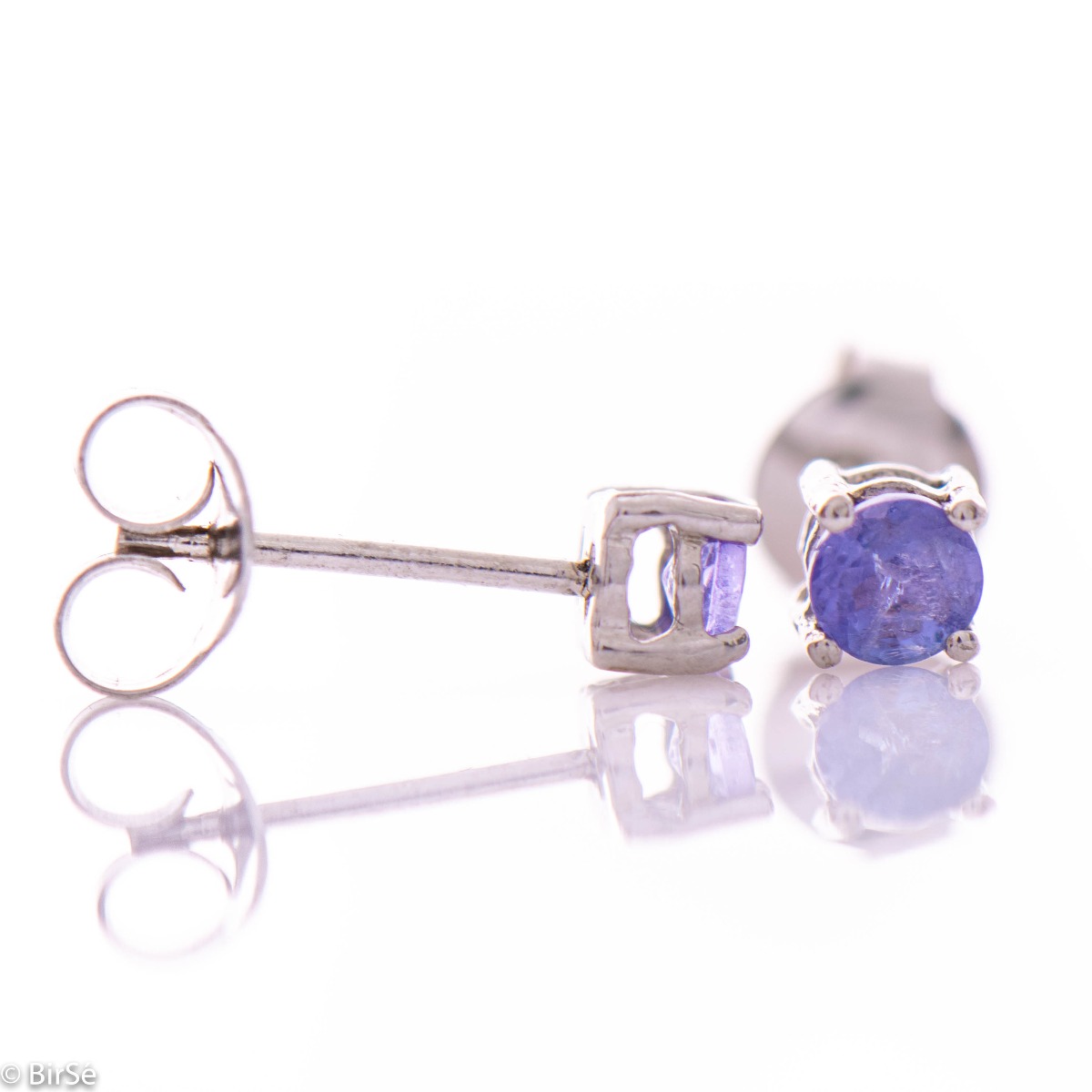 Fine stud earrings combining delicate rhodium silver craftsmanship with the purple glow of natural tanzanite stone.