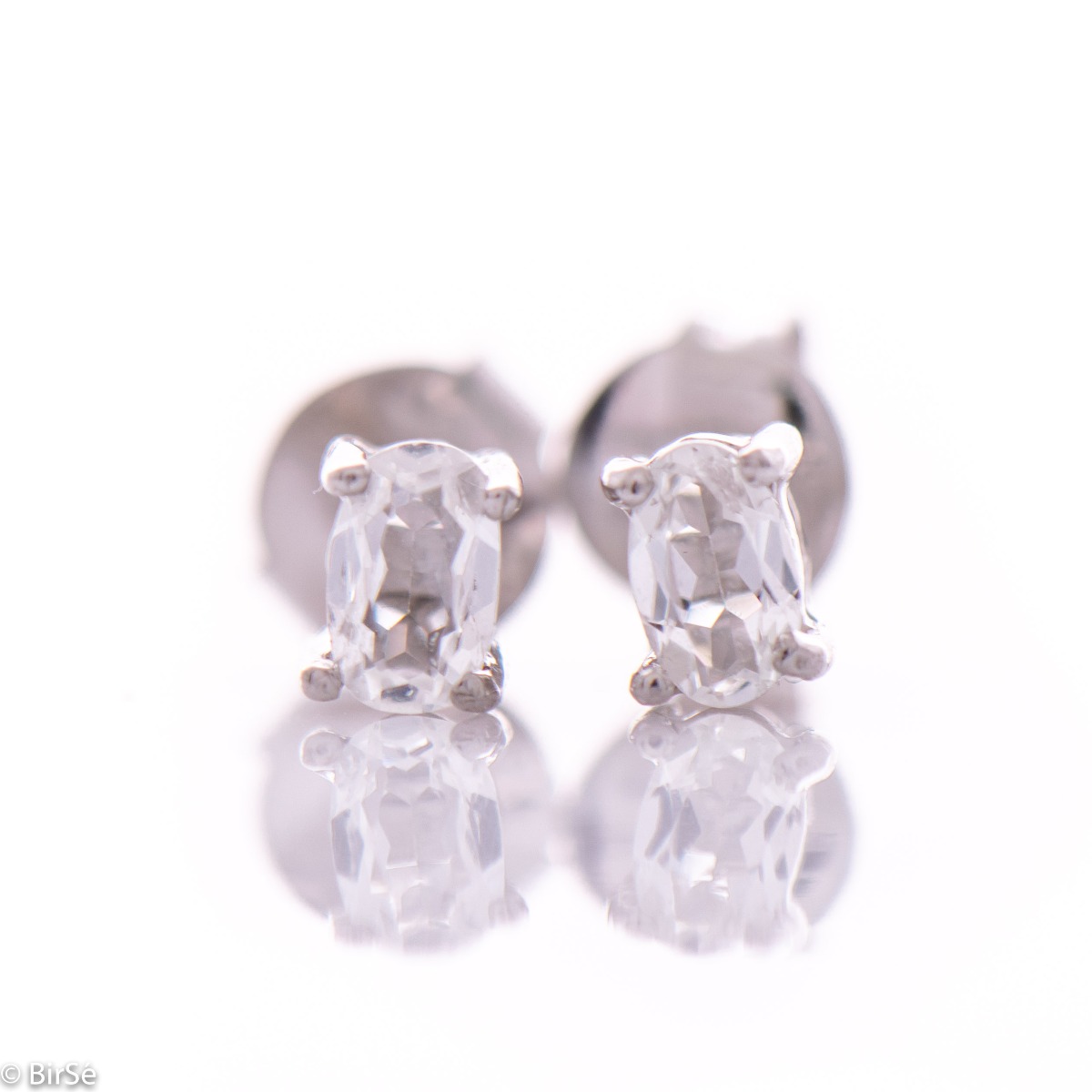 Radiant women's earrings on a pin - 5x3 mm - combining delicate rhodium-plated silver craftsmanship with the shine of a natural white topaz stone.