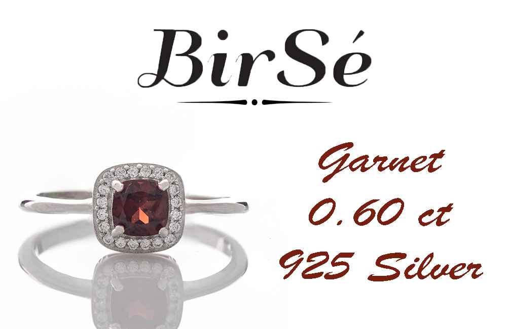 An exquisitely crafted ring of brilliant rhodium-plated silver with interestingly shaped details. A central role is occupied by a magnetic natural garnet, beautifully surrounded by small fine zircons. Can be combined with earrings and pendant from the set