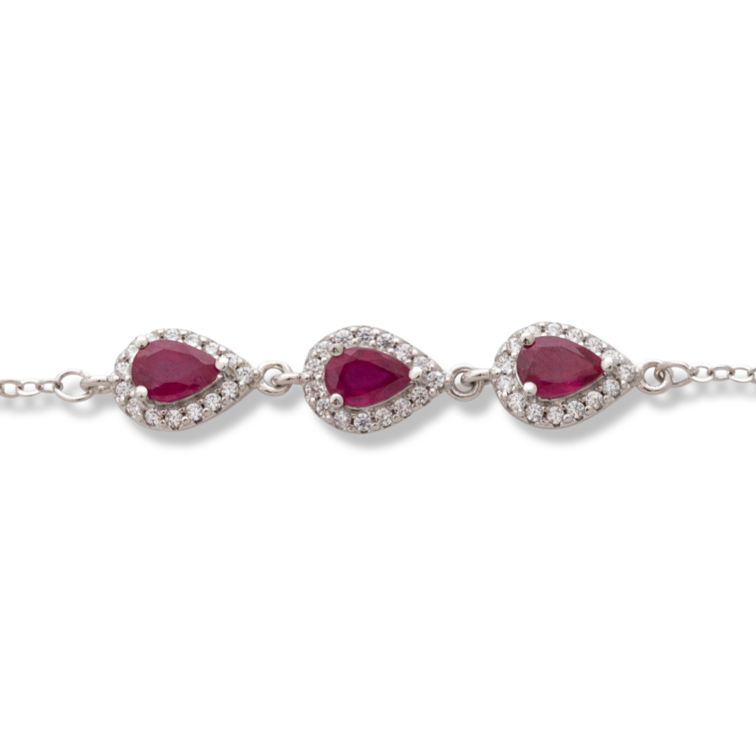 Elegant women's bracelet made of soft silver with natural ruby ​​drops, decorated with exquisite and subtle elements and sparkling zircons. The bracelet has an extension, for greater convenience when adjusting the length.