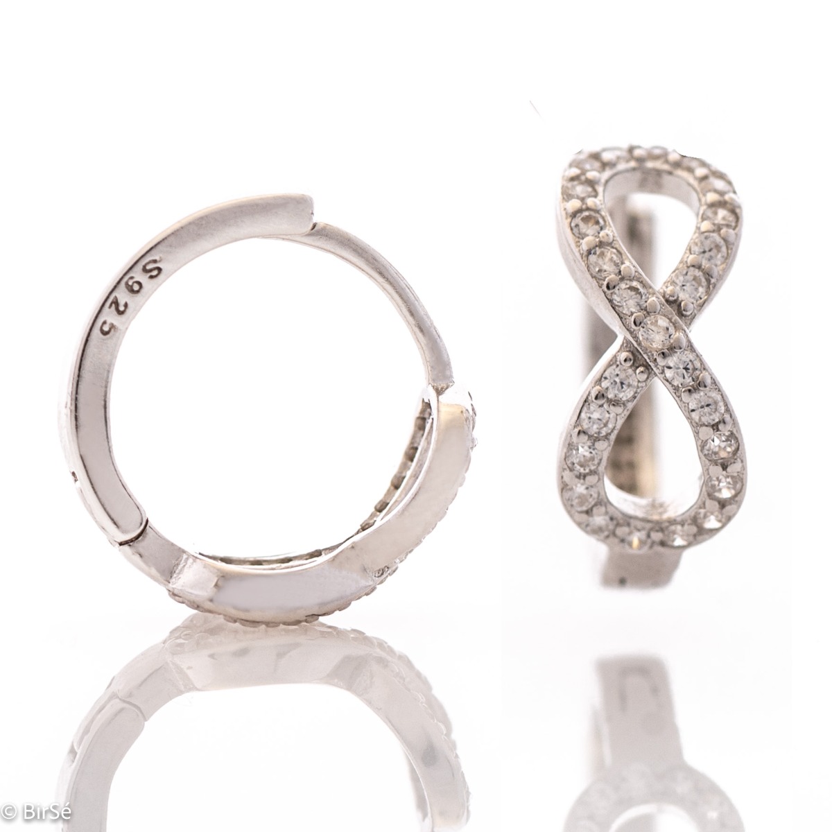 Delicate ladies' earrings - rings made of rhodium-plated silver with a comfortable English clasp. The front side of the earrings is shaped like an exquisite infinity, carefully decorated with zircons.