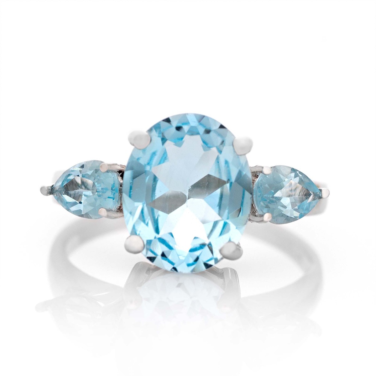 An alluring ladies' ring crafted from delicately rhodium-plated silver that elegantly holds a delightful natural blue topaz. The ring is part of a lovely set that includes dangling earrings and a sky blue topaz pendant.