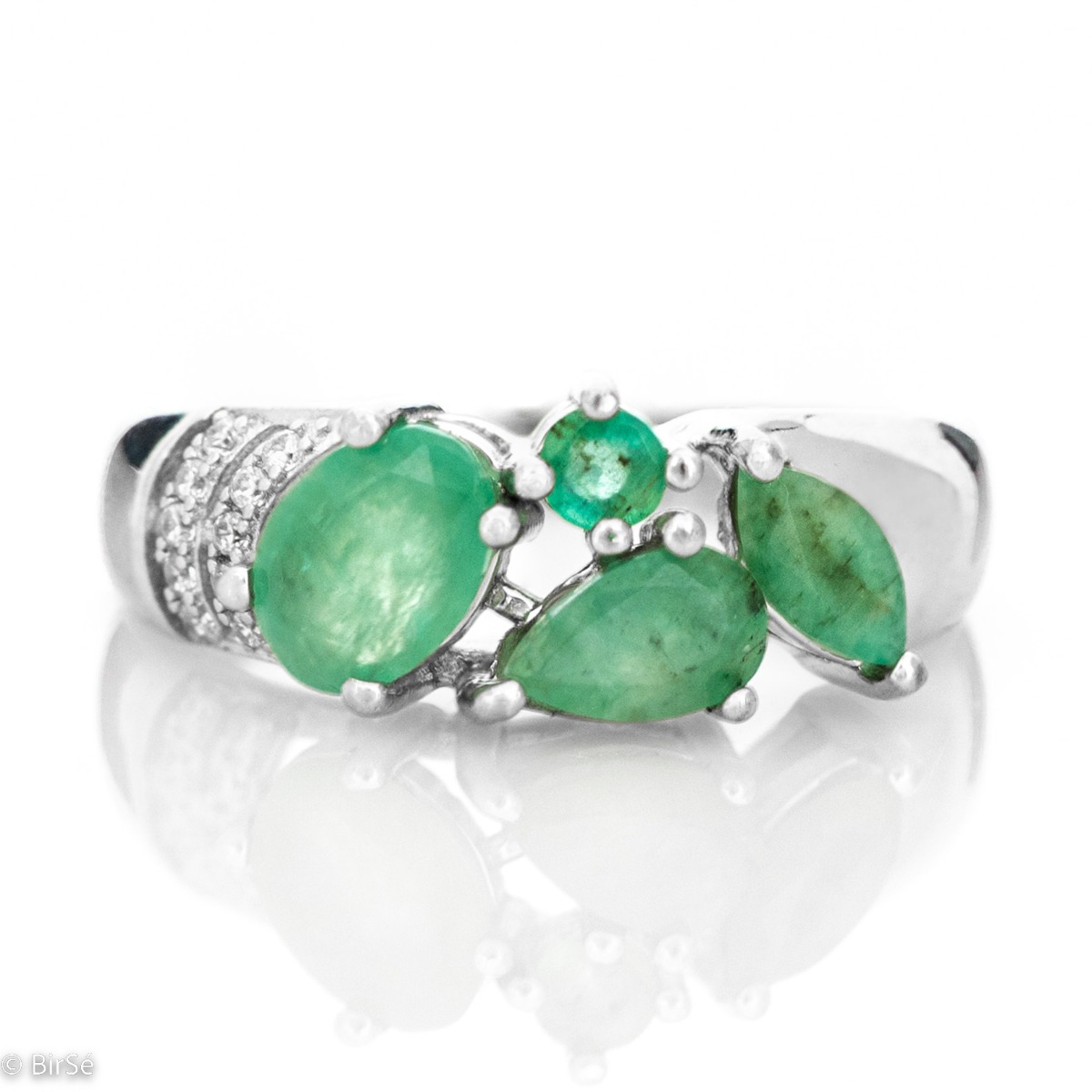 The captivating beauty of natural emeralds expressed in full force in a regal silver ring. The combination with sparkling zircons makes the jewelry even more charming.