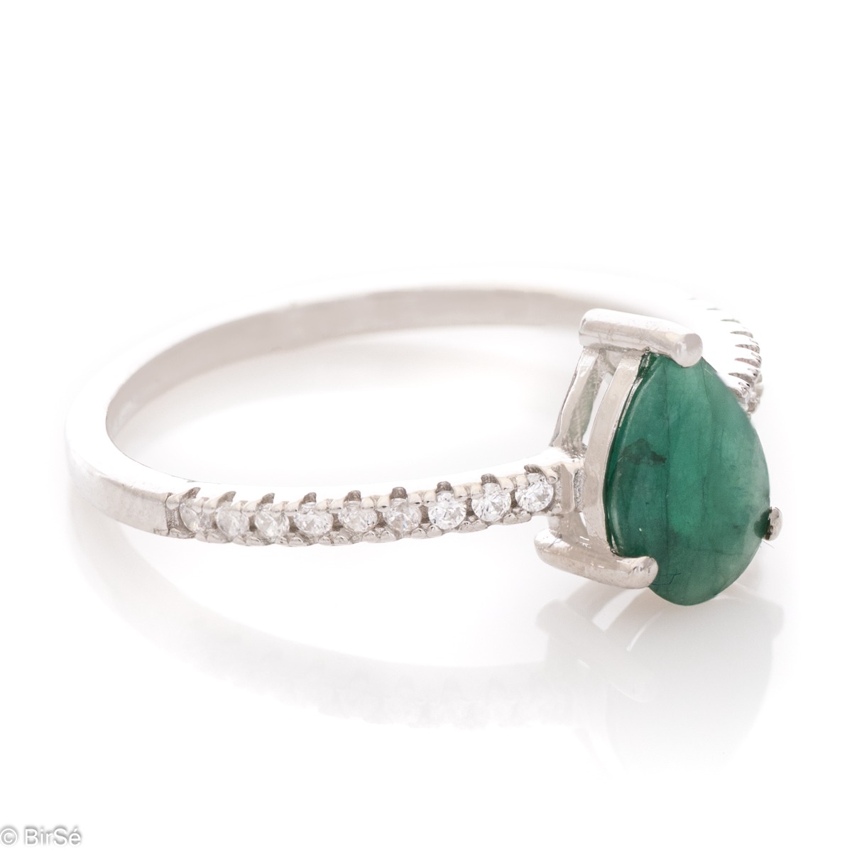 Delicate women's ring with a radiant natural emerald stone with a beautiful teardrop shape, in the company of sparkling zircons and made entirely of rhodium-plated silver.