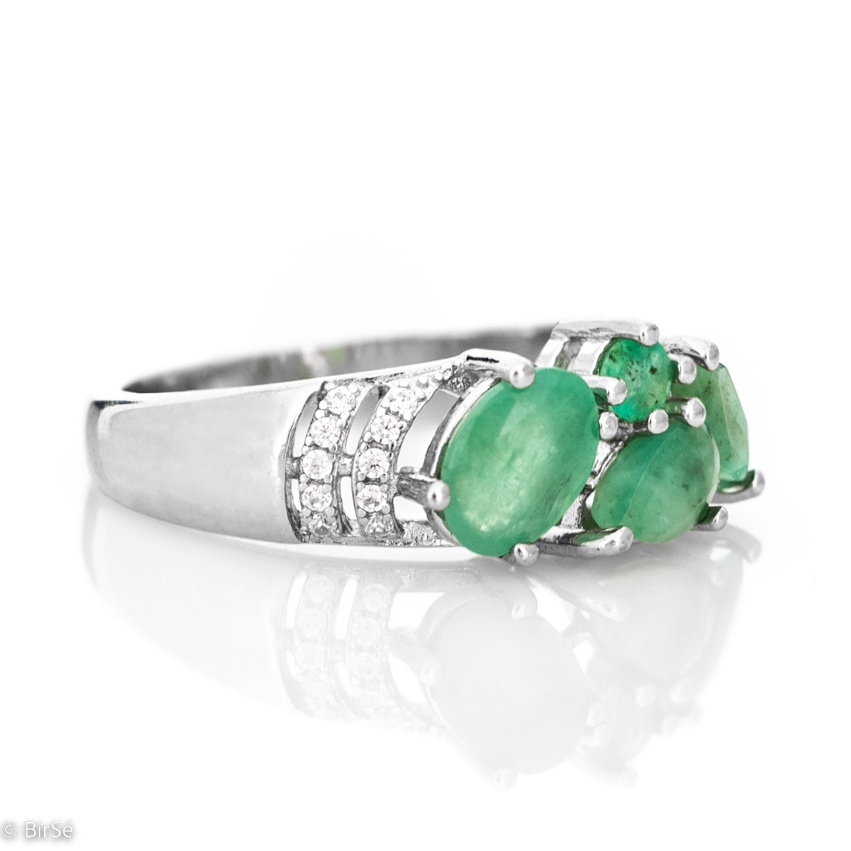 The captivating beauty of natural emeralds expressed in full force in a regal silver ring. The combination with sparkling zircons makes the jewelry even more charming.