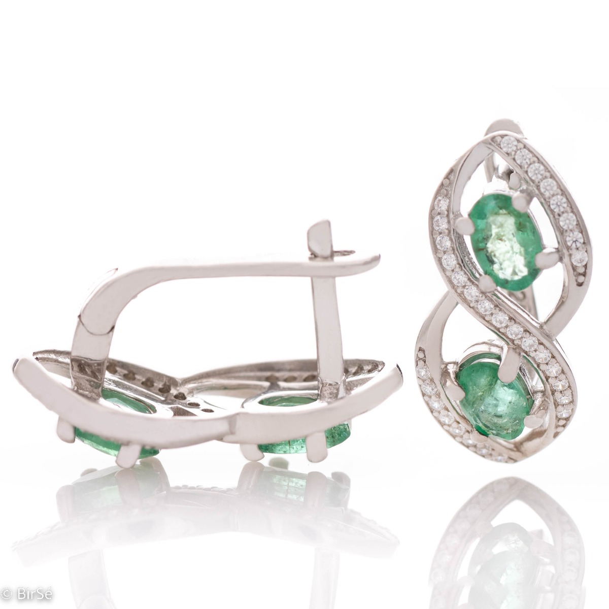 Stunning infinity rhodium-plated sterling silver earrings, exquisitely embellished with glittering cubic zirconias encircling gorgeous emeralds. Complete with a ring of the same design.