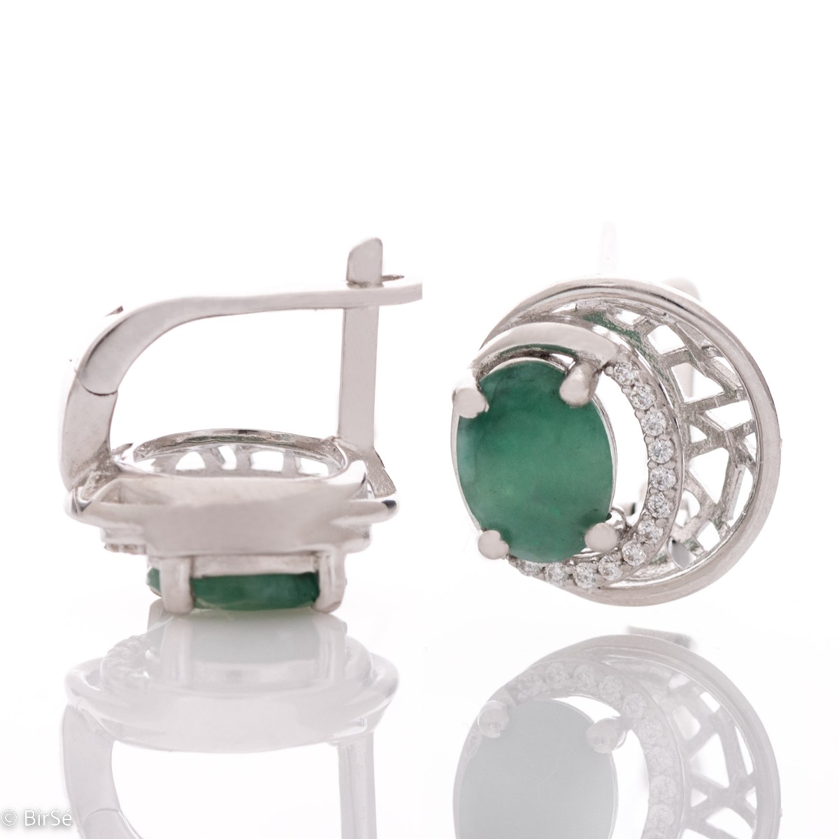 Elegant silver earrings with a modern look and English clasp. Stylish designer craftsmanship from a fine combination of rhodium-plated silver with captivating natural emeralds. Complete with silver pendant and silver ring from the same collection.