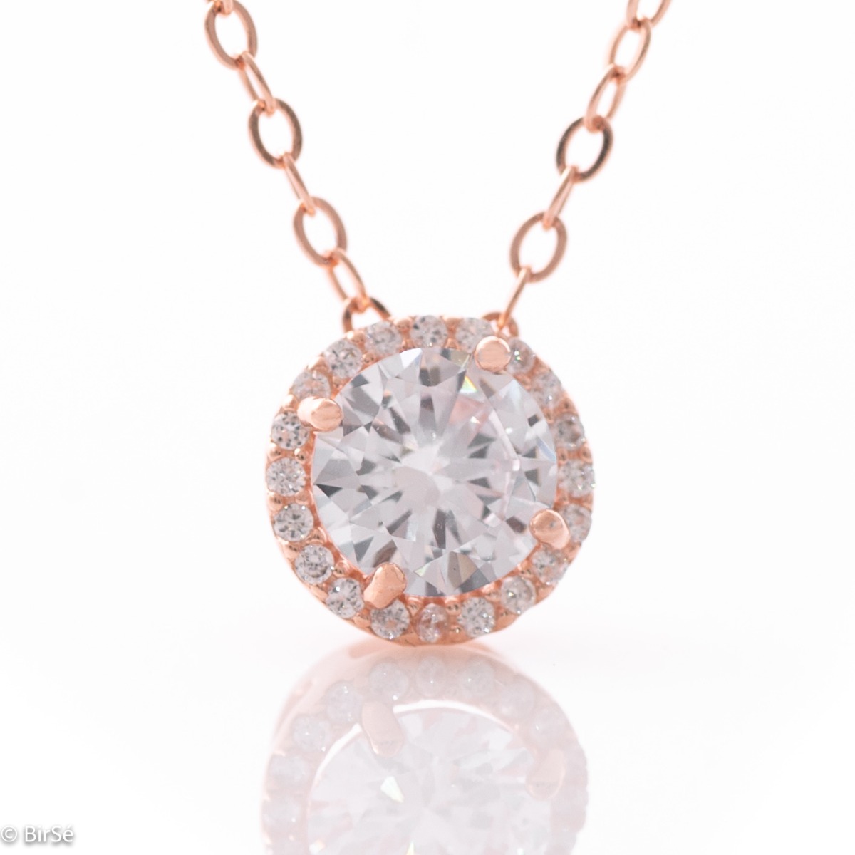 An elegant women's necklace with exquisite craftsmanship entirely made of rose silver. A dazzling zircon is attached to a fine chain, accompanied by numerous small zircons.