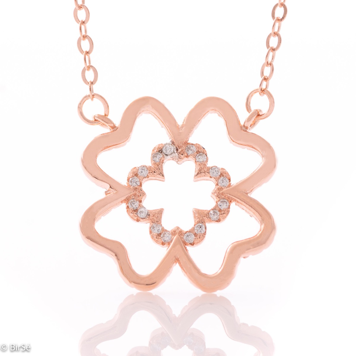 Fine silver clover necklace. Beautifully crafted in rhodium-plated rose silver, it gently wraps around a delicate four-leaf clover, fully encrusted with cubic zirconia. The chain is delicate, with an extender to be worn according to the lady's preference.