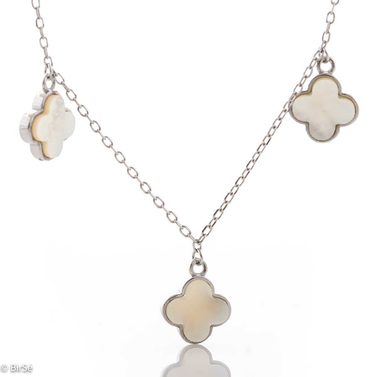 Exquisitely crafted women's necklace of fine rhodium-plated silver, with beautifully shaped pendants - clovers of delightful mother-of-pearl. The jewelry is suitable for any lady's casual or formal outfit.