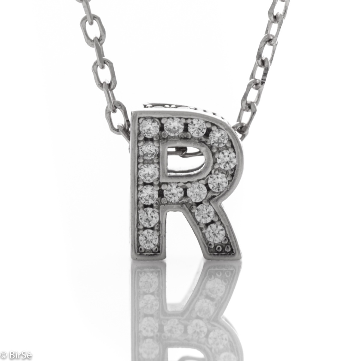 Finely crafted silver letter R necklace for women, all covered with glittering zircons. An attractive piece of jewelry in which the delicate beauty of rhodium-plated silver is skilfully combined with the brilliance of zircons.